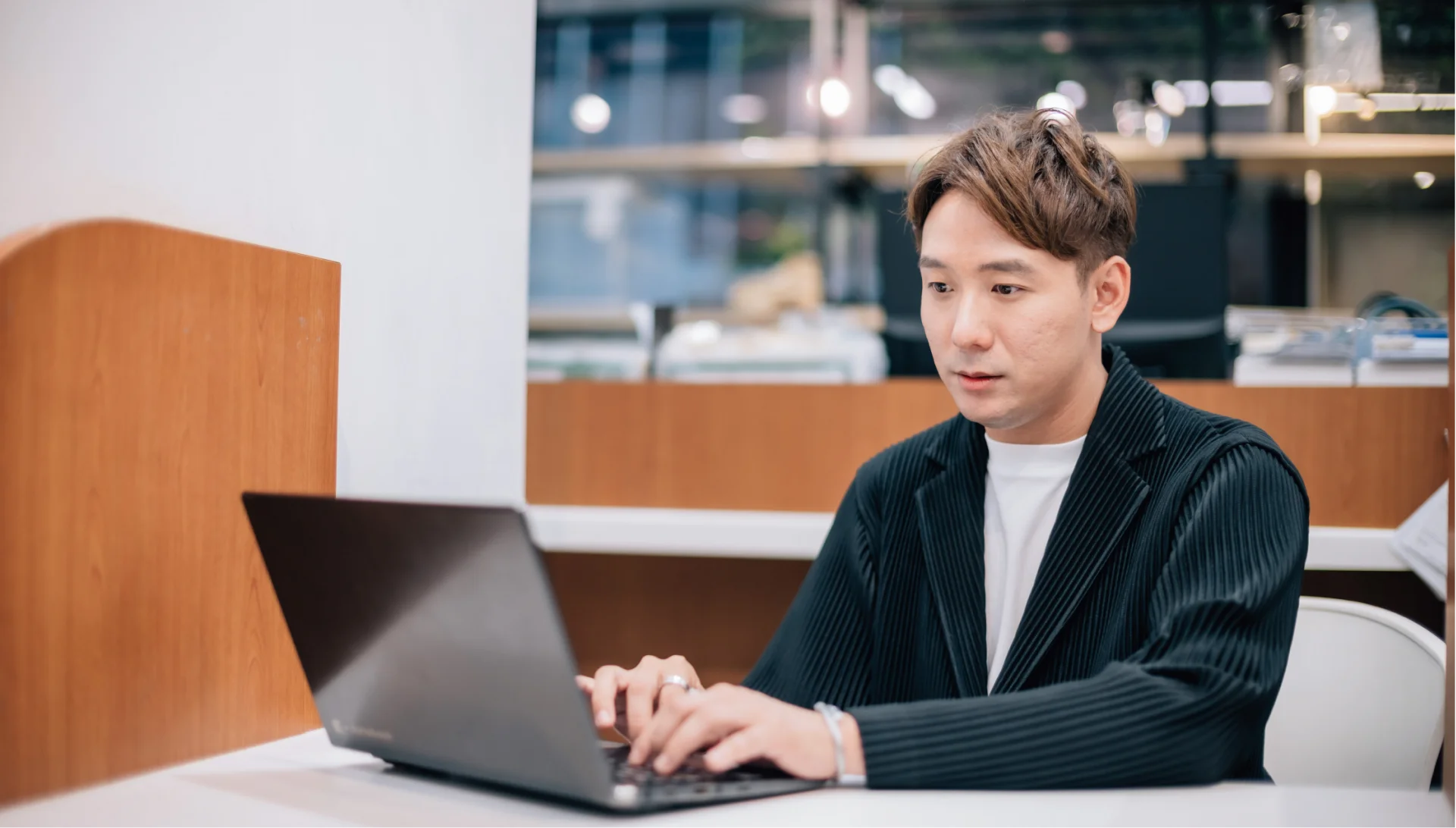 本部教育課副理 方 Sam 在 2nd STREET 使用筆電工作的照片